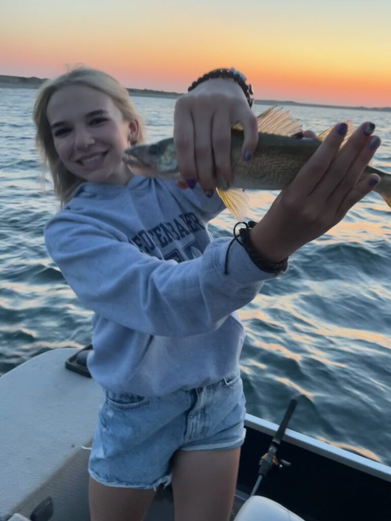girl holding fish caught on Lake Diefenbaker