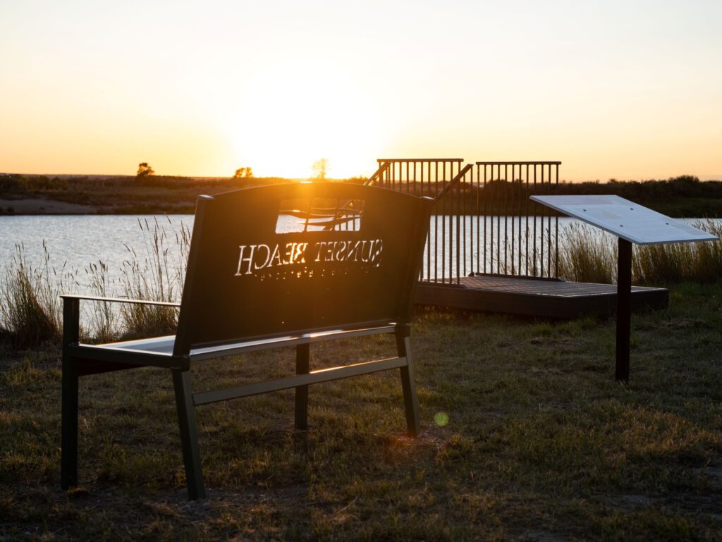 Sunset shining through a bench at Sunset Beach